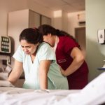 A pregnant woman being assisted by a nurse in hospital (Photo: Hannah Barata)