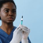 A nurse holding a syringe (Photo: Cottonbro Studio)