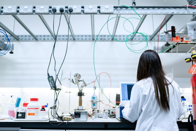 A scientist working in a lab with her back to the camera (Photo: ThisIsEngineering)